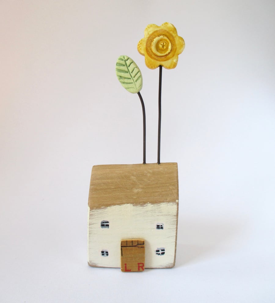 Little wooden house with yellow flower