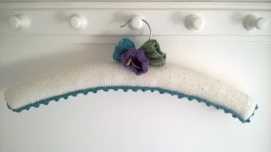 Hand knitted crocus topped cream coat hanger