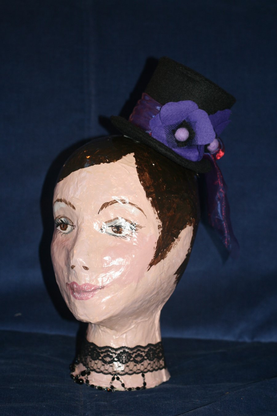 Black felt top hat with purple poppies and bow