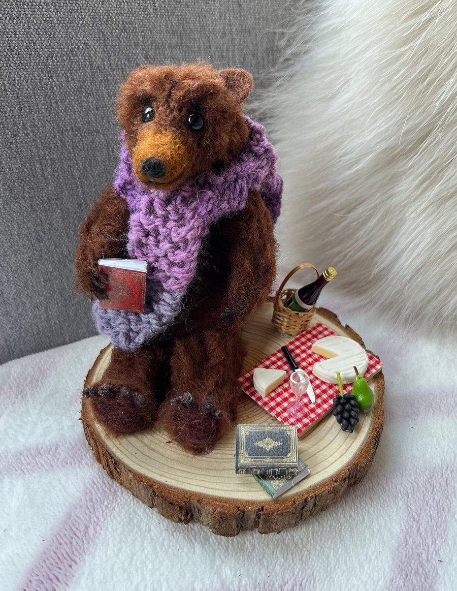 Needle felted Scruffy Bear character, wearing a hand knitted scarf with picnic