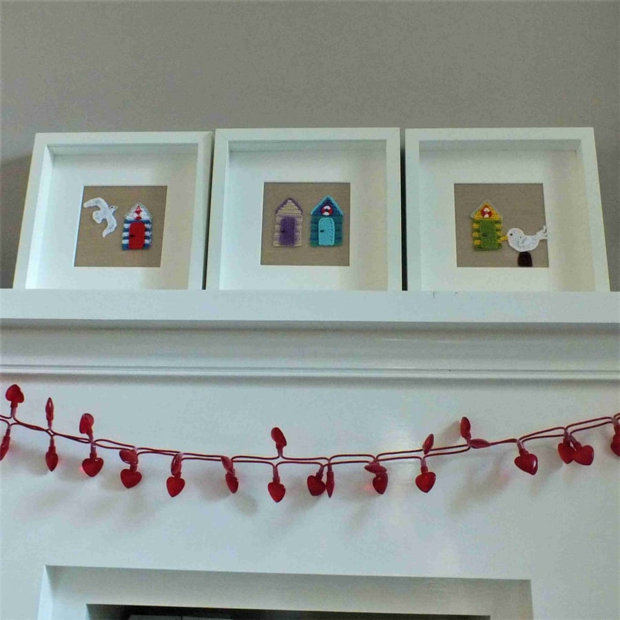 Three crocheted pictures in frames - beach huts