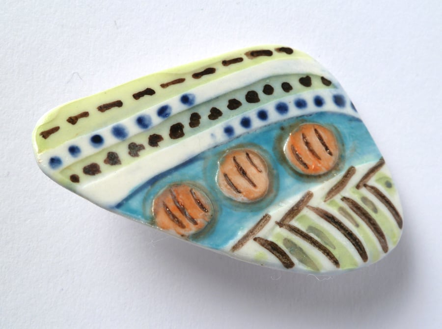 A unique painted porcelain brooch, hand made in Winchester.