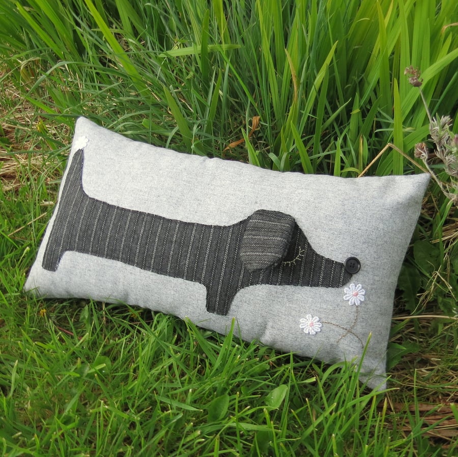 A snoozy dachshund cushion, complete with cushion pad. 