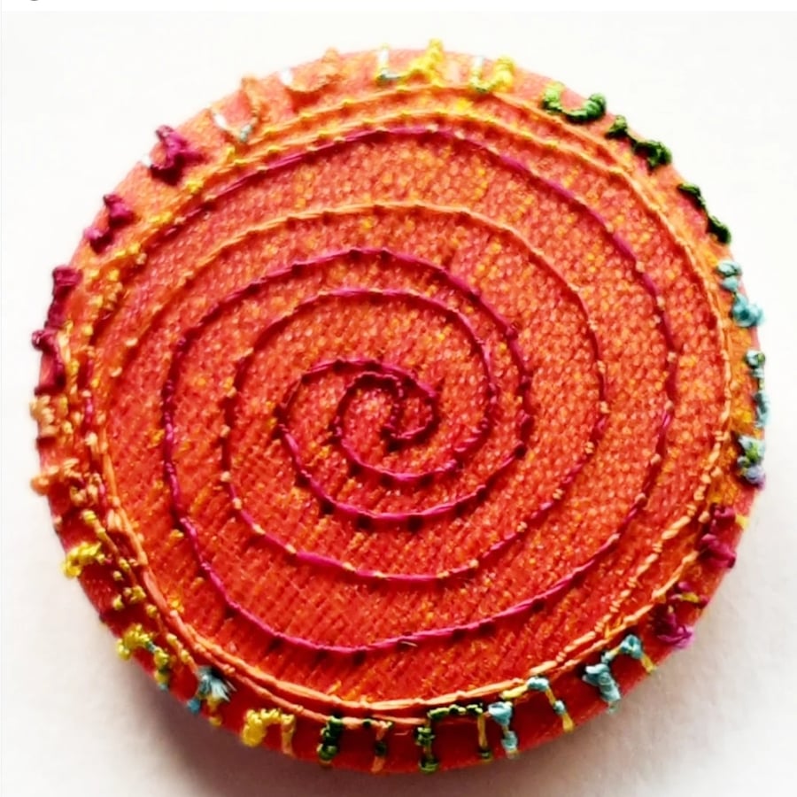 One Inch Badge Orange Spiral 