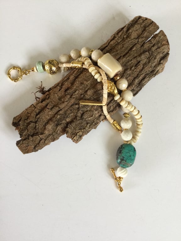 Multistrand cream and gold coloured bracelet.