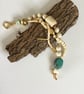 Multistrand cream and gold coloured bracelet.