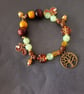 Elasticated beaded red squirrel, tree of life and gold acorn charm bracelet  - Image 4