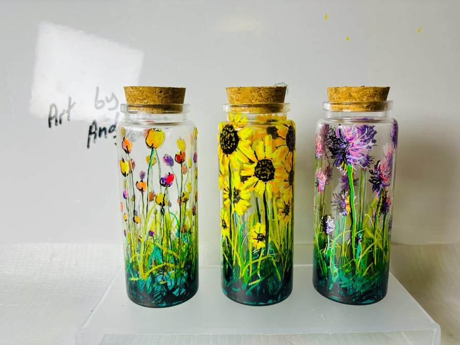 A set of three hand painted and fired jars by Andrew Jenkins 