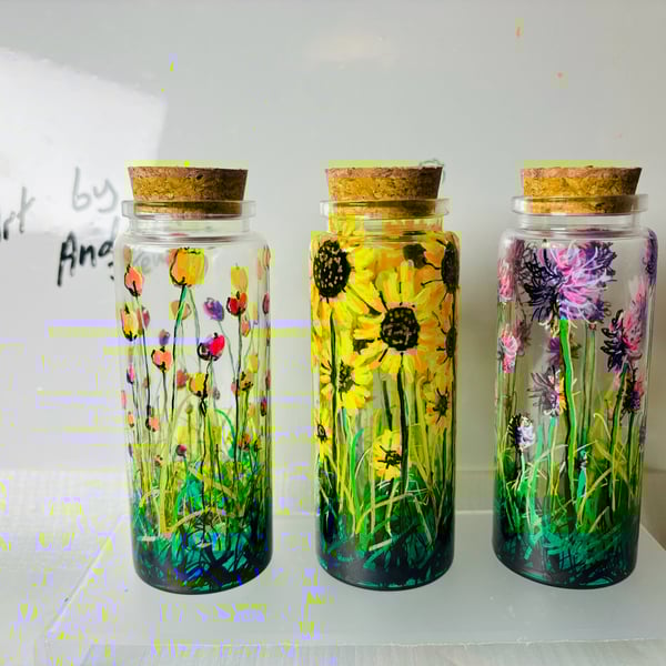 A set of three hand painted and fired jars by Andrew Jenkins 