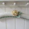 Coat hanger clothes hanger with primrose yellow ranunculus flower