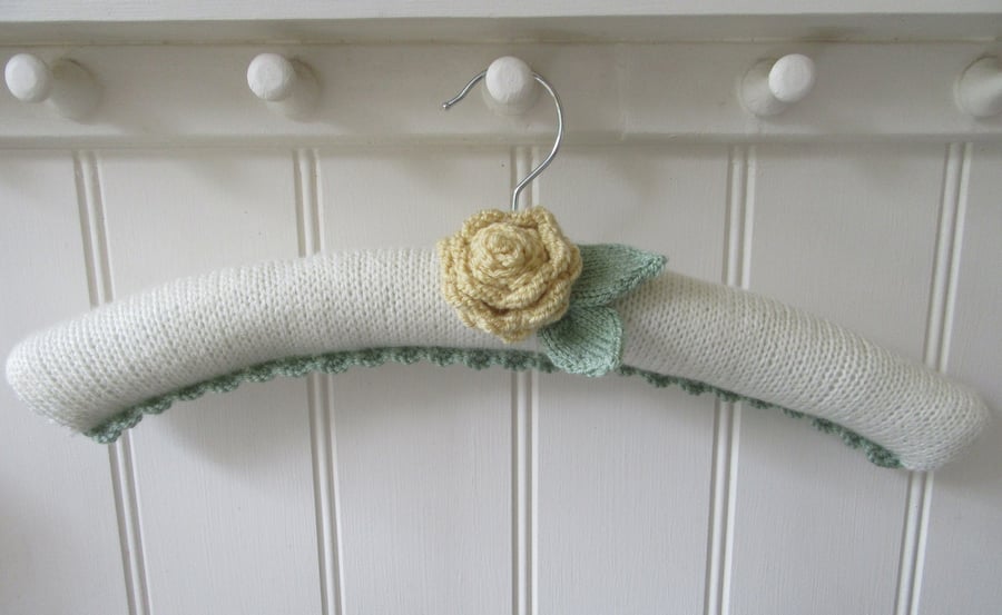 Coat hanger clothes hanger with primrose yellow ranunculus flower