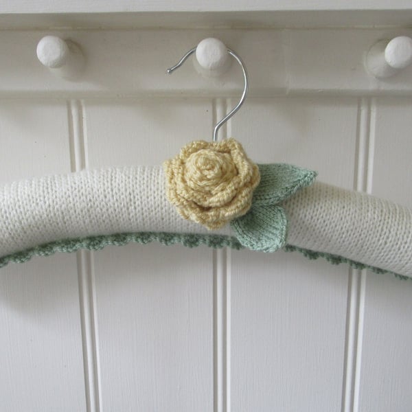 Coat hanger clothes hanger with primrose yellow ranunculus flower