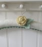 Coat hanger clothes hanger with primrose yellow ranunculus flower