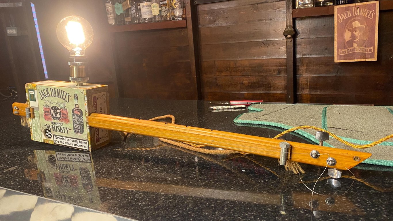 JD Cigar box guitar Up-cycled to a vintage style lamp Hung or free standing.