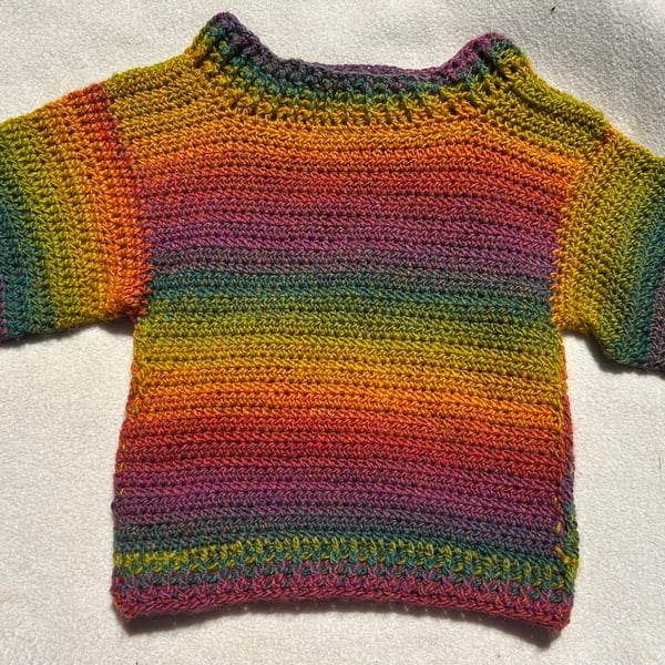 Rainbow jumper for a small child, perfect for festivals and every day wear.