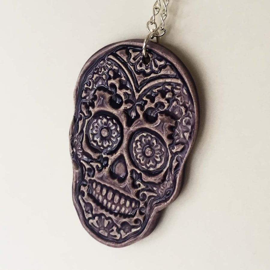  Pottery purple skull pendant on 20 inch chain. Ceramic skull Day of The Dead