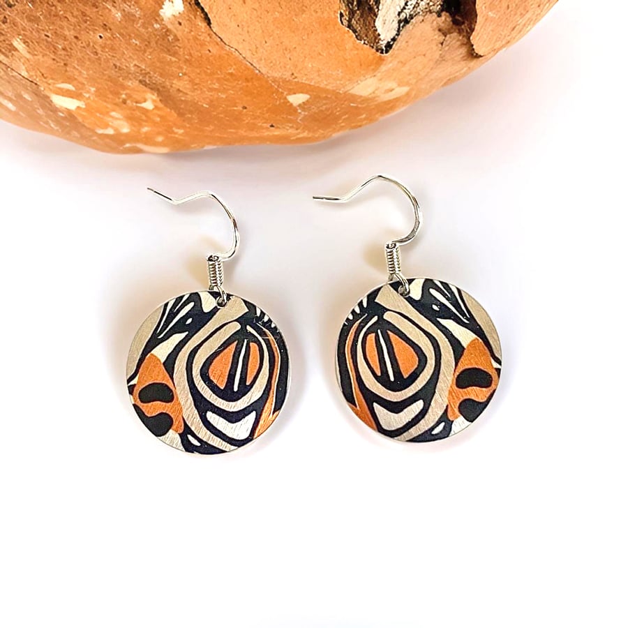 Drop earrings, black and tan abstract discs on sterling silver ear wires (829A)