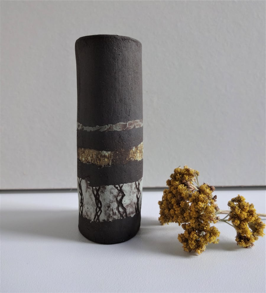 Tiny gift, matt black ceramic bud vase with abstract bands of colour.