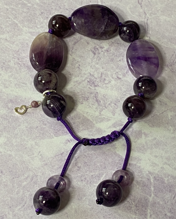 Purple macrame cord bracelet with smooth oval amethyst stones