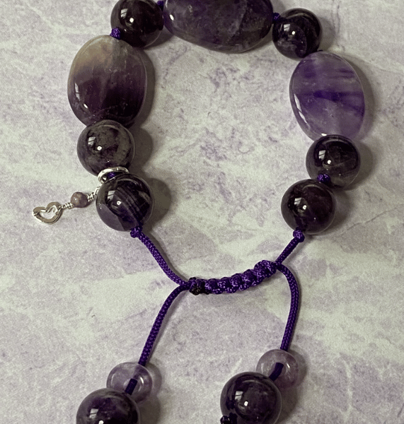 Purple macrame cord bracelet with smooth oval amethyst stones