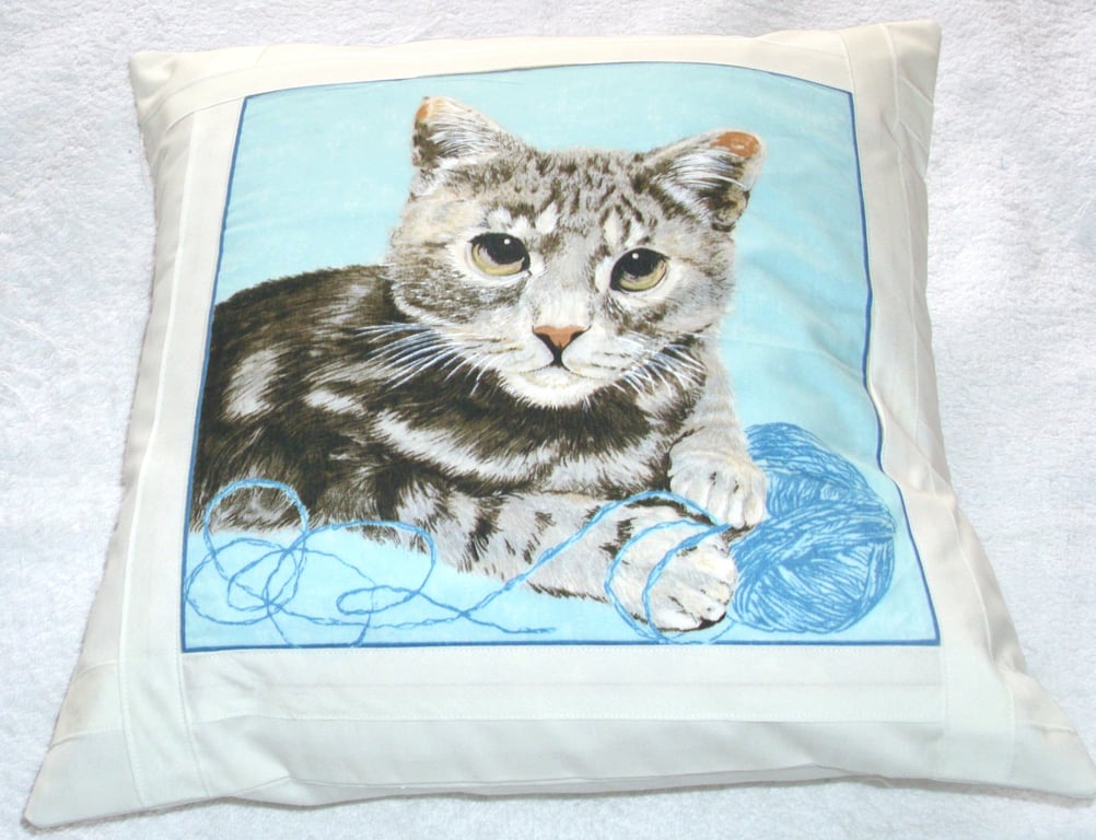 Tabby cat lying with ball of wool