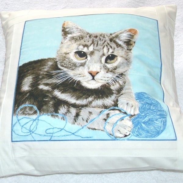 Tabby cat lying with ball of wool