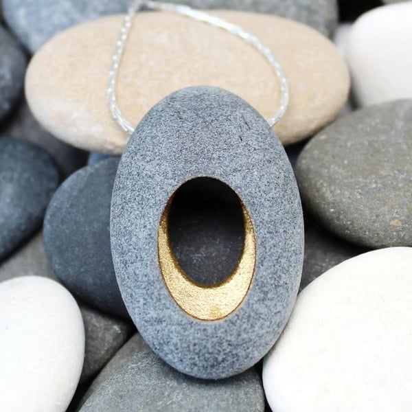 Pebble pendant necklace, nature inspired with a golden hollow centre.