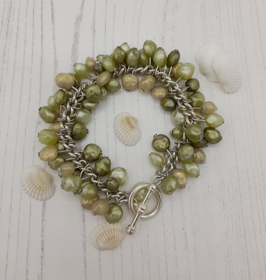 Green faux pearls charm style bracelet