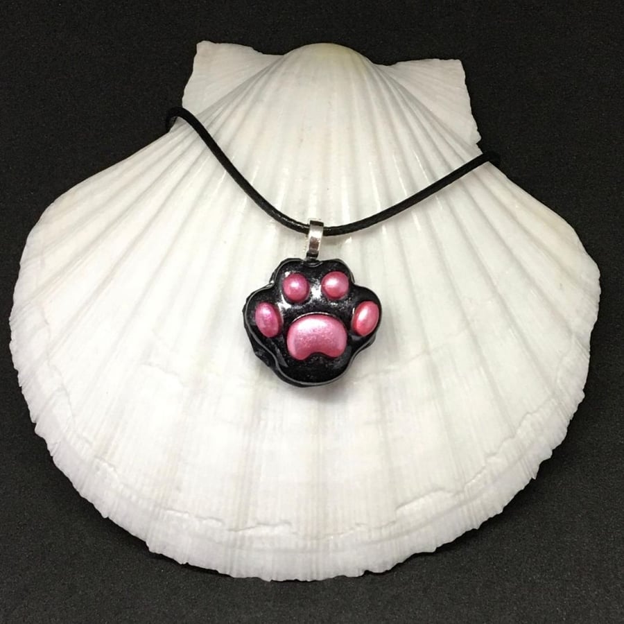 Black paw print pendant with pink toe beans pendant and chain.