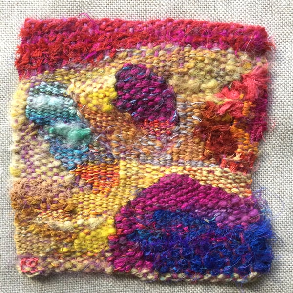 Unframed handwoven mini tapestry weaving, in pink, blue, red and yellow 