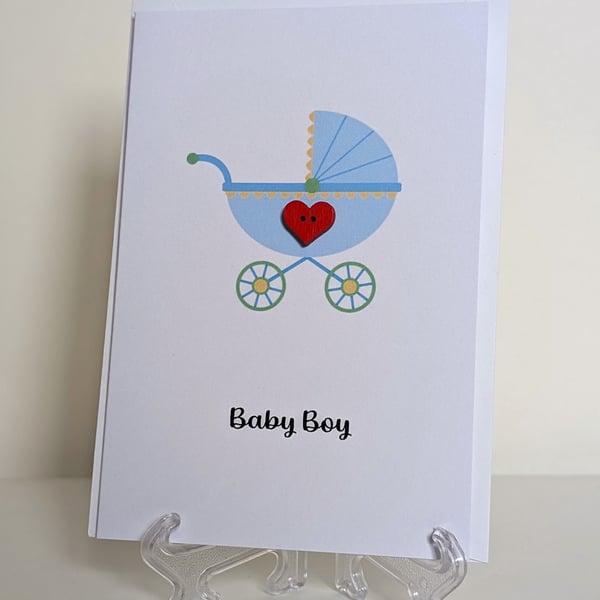 Baby boy pram with red heart button greetings card 