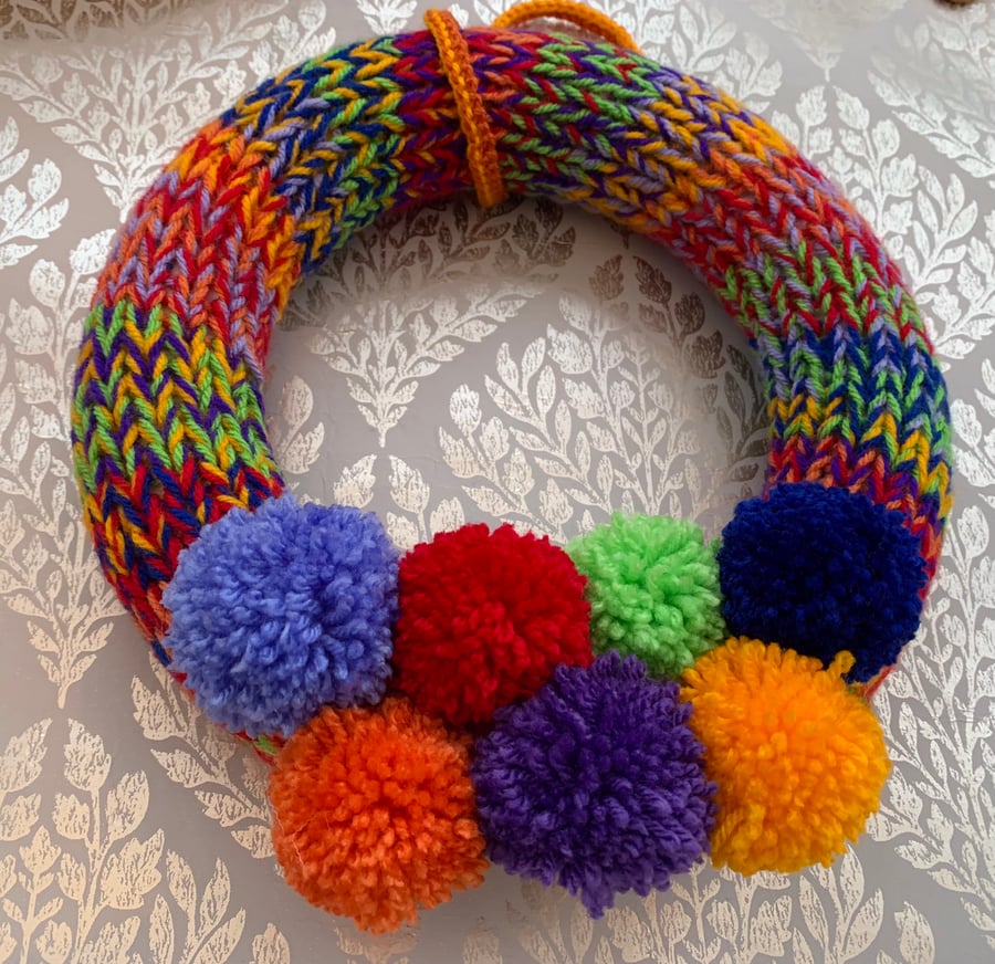 Knitted rainbow  wreath with pom poms 