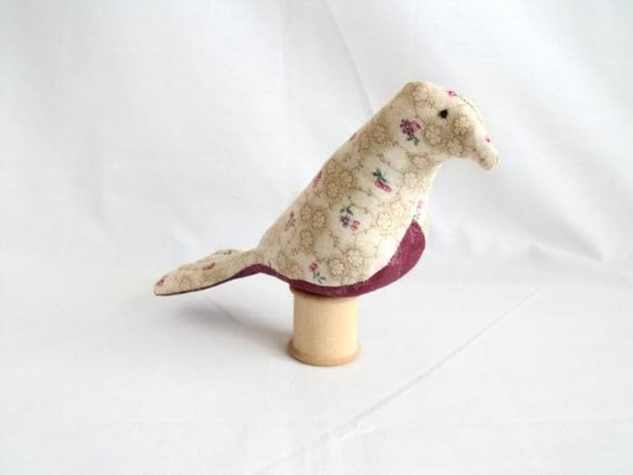 novelty bird ornament or bird pin cushion on a vintage wooden bobbin, beige