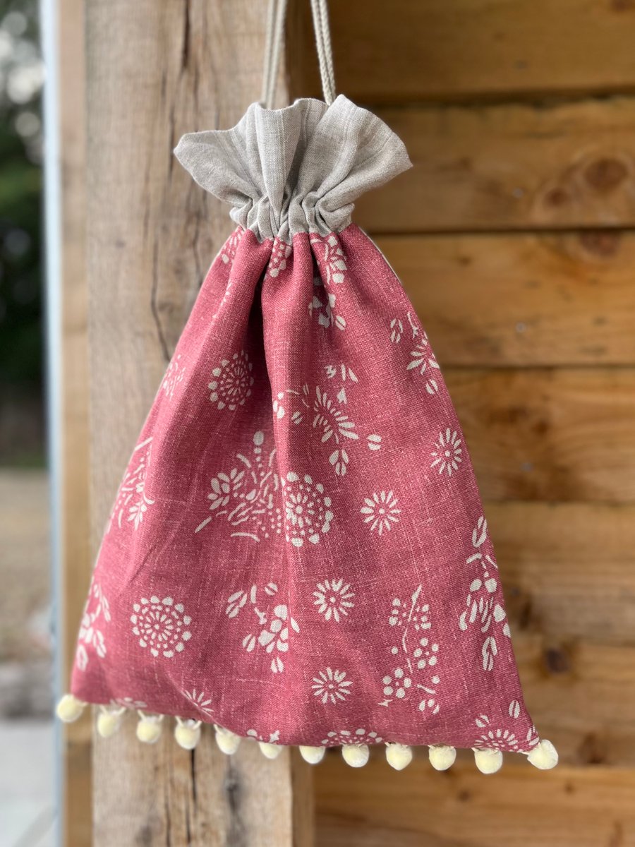 Pink floral print linen drawstring bag with soft striped linen lining