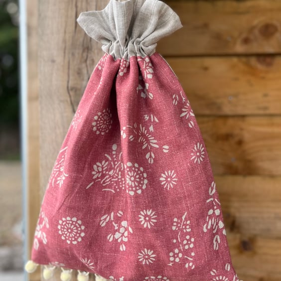 Pink floral print linen drawstring bag with soft striped linen lining