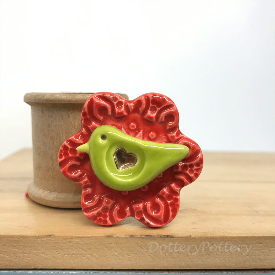 Ceramic bird on a flower brooch