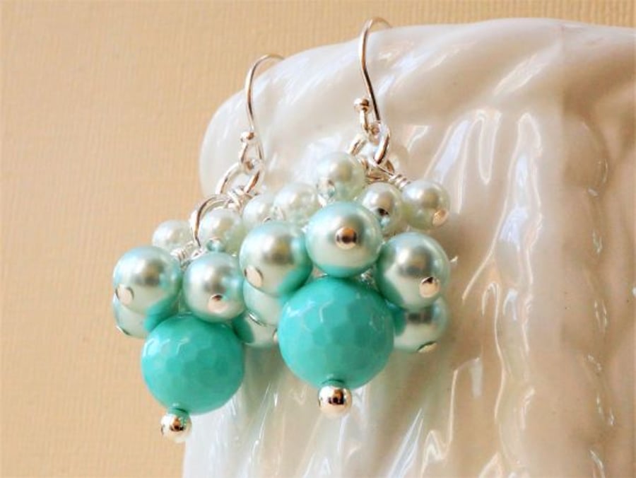 Shell pearl cluster earrings in shades of aqua green.
