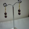 AUBERGINE AND GOLD PLATED RHINESTONE RONDELLE EARRINGS.  376