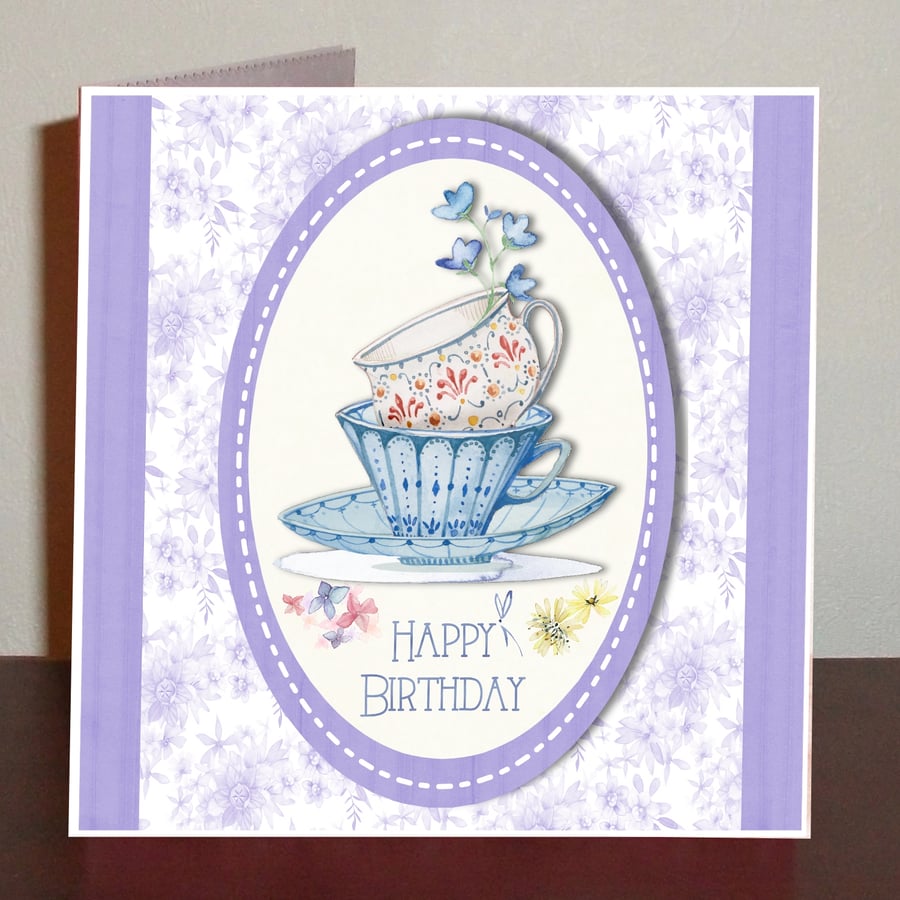Female birthday card with stacked teacups and flowers