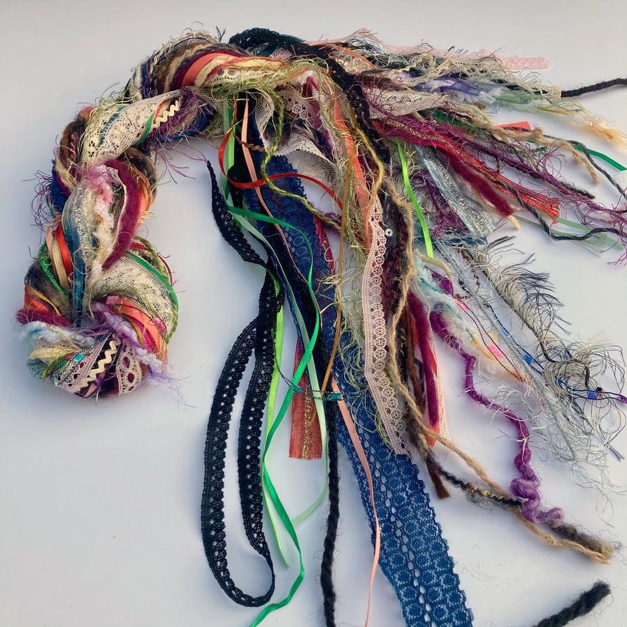 Bundle of fancy yarn, ribbons, lace and trim