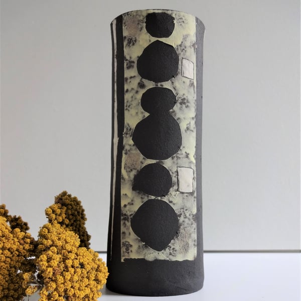 Gloria.  Black ceramic vessel with mid century lemon, grey, white motifs. 