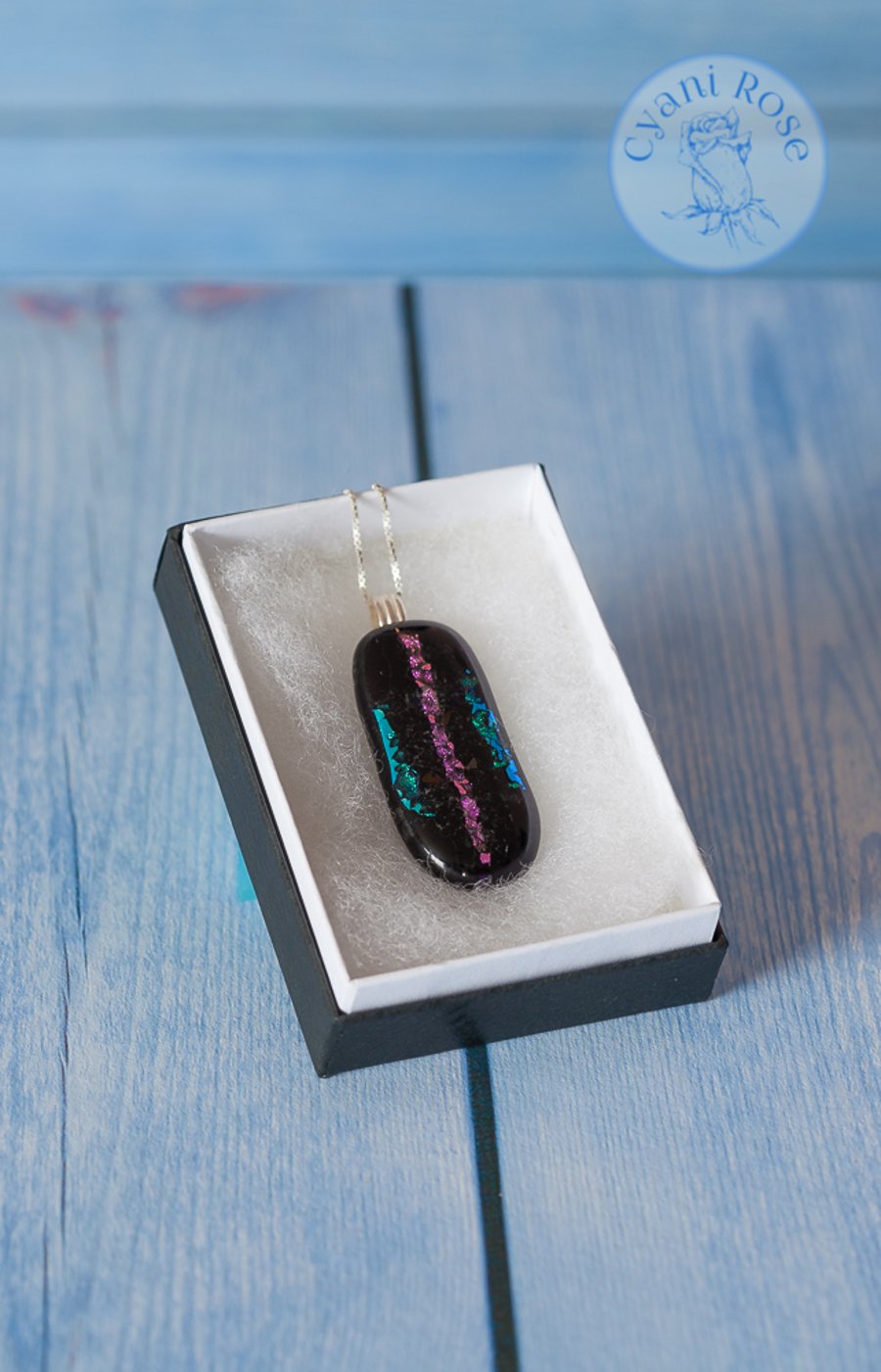 Black fused glass pendant with sparkle stripes in turquoise and pink
