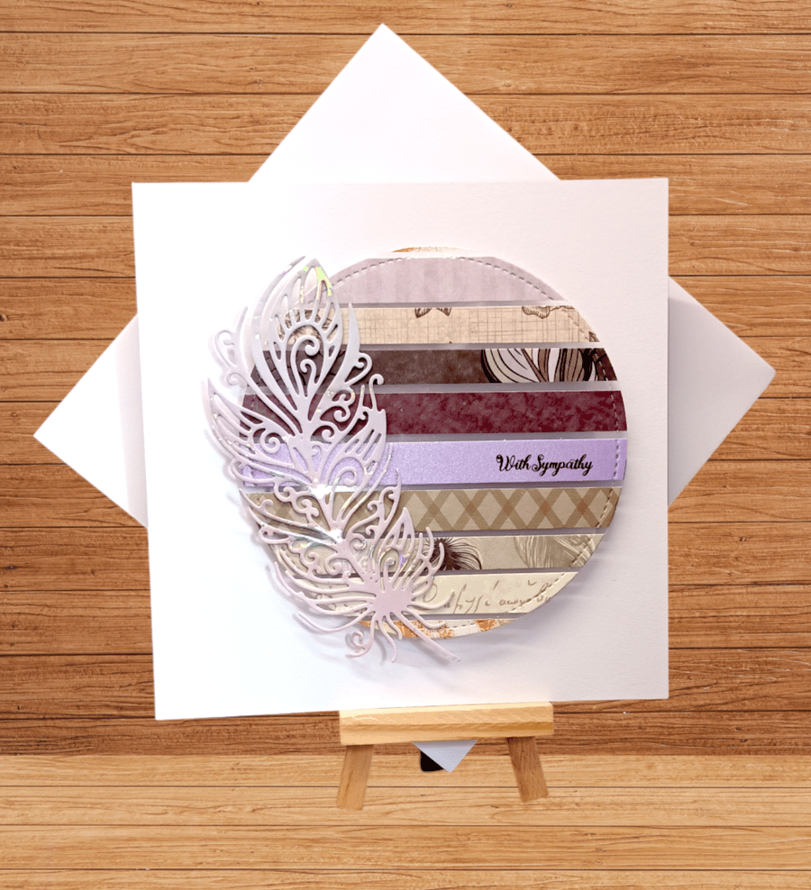 Delightful striped sympathy card with feather decoration