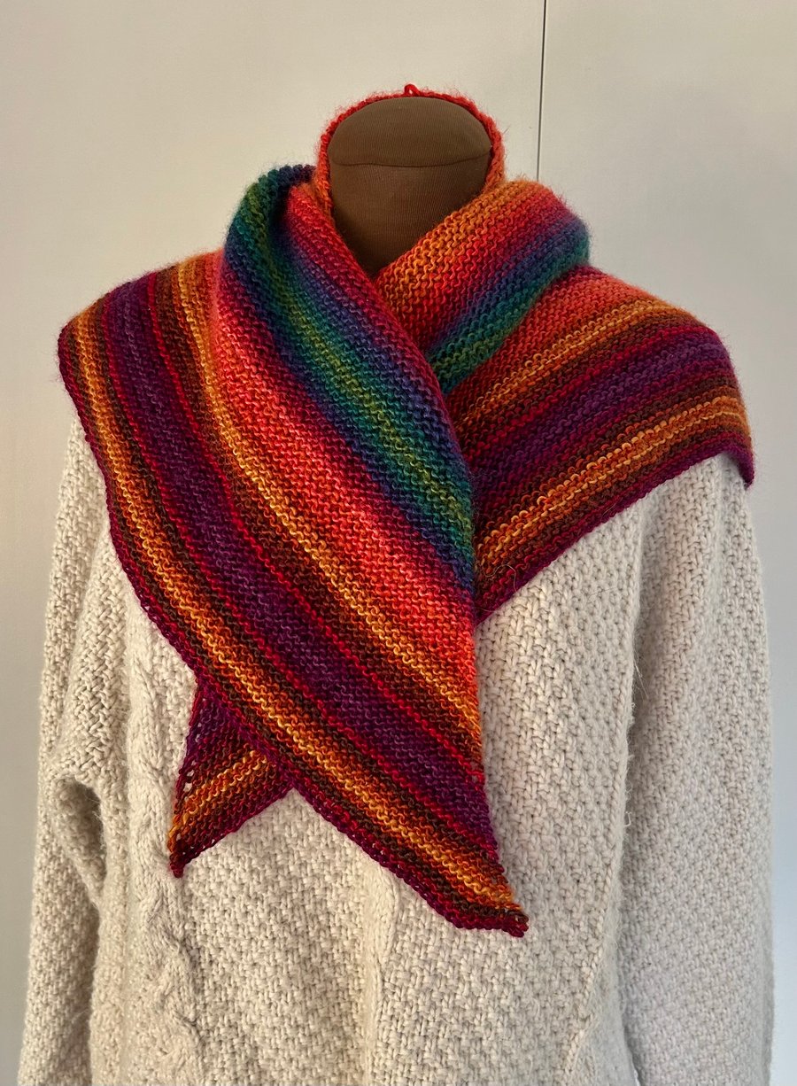 Bright multicoloured hand knitted shawl scarf