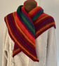 Bright multicoloured hand knitted shawl scarf