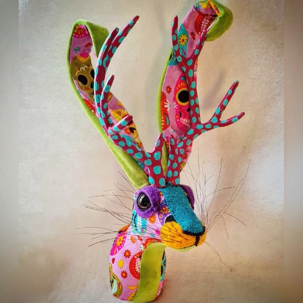 Faux jackalope head wall mount in Day of the Dead skull style fabric