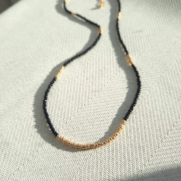 Glass beaded necklace, black and gold, 16 to 18 inches