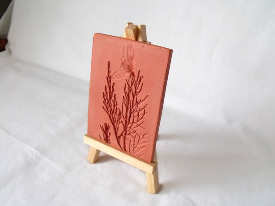 terracotta impressed clay tile displayed on an easel, number 4 of 8 available