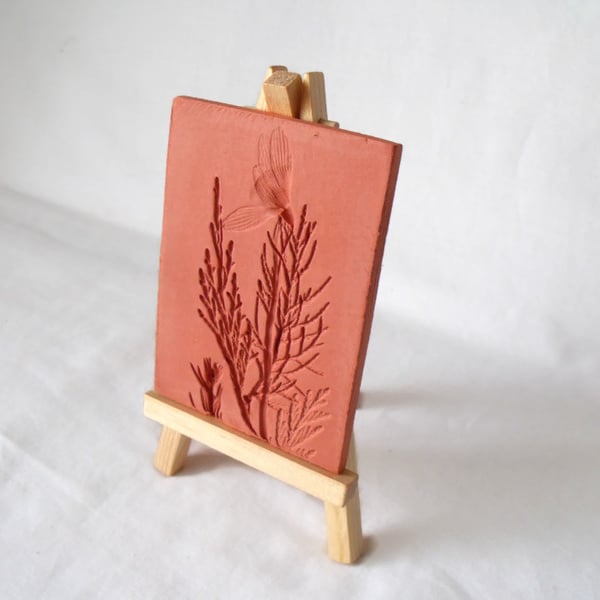 terracotta impressed clay tile displayed on an easel, number 4 of 8 available