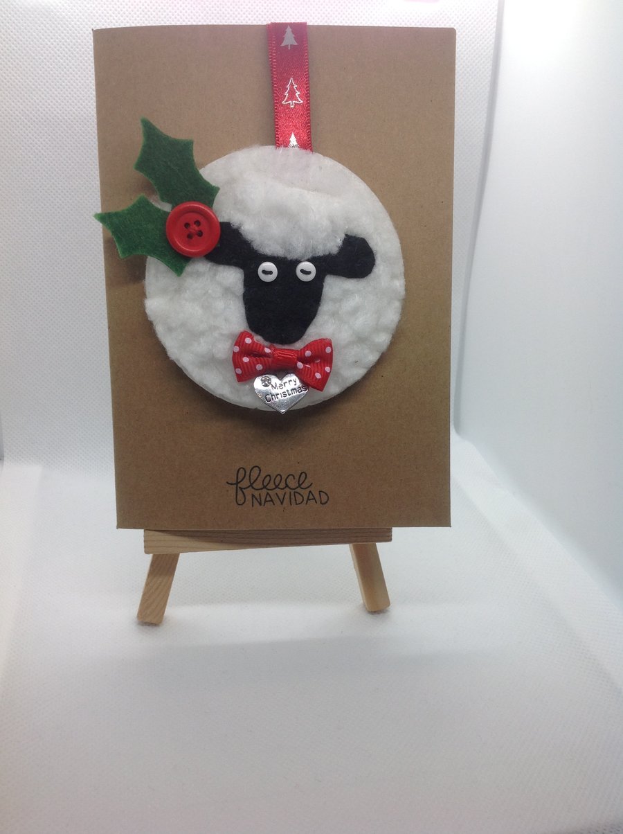 Handmade felt and faux fleece sheep decoration attached to card with envelope.